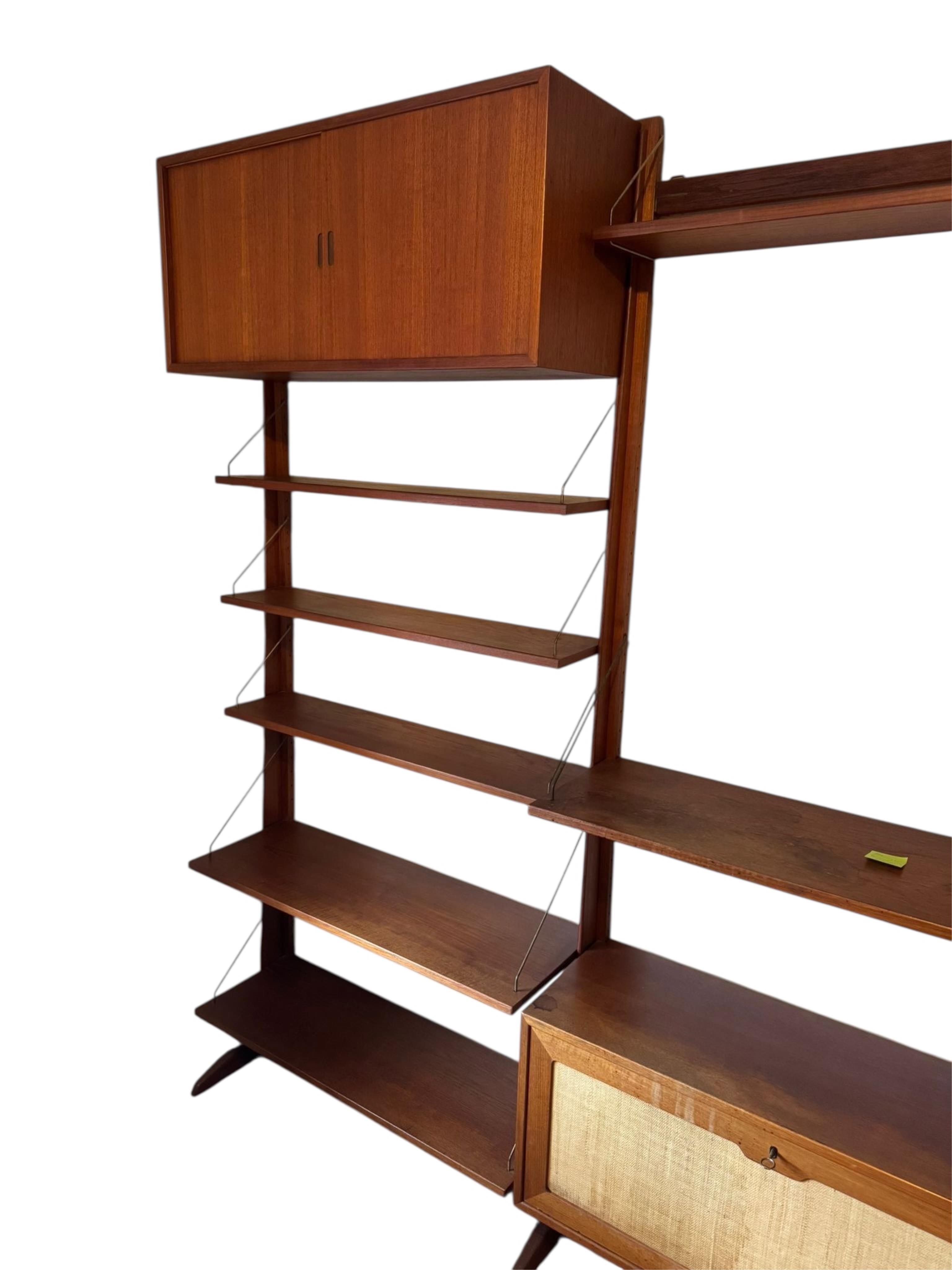 A mid century teak Ladderax type wall unit, width 270cm approx., depth 32cm, height 210cm